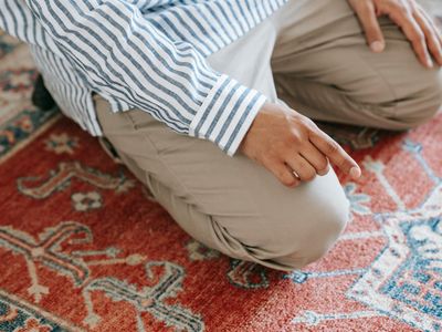 Person hands in a prayer position during meditation.